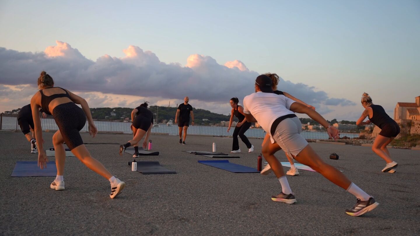 Outdoor group training session on the Antibes seafront at sunset, French Riviera