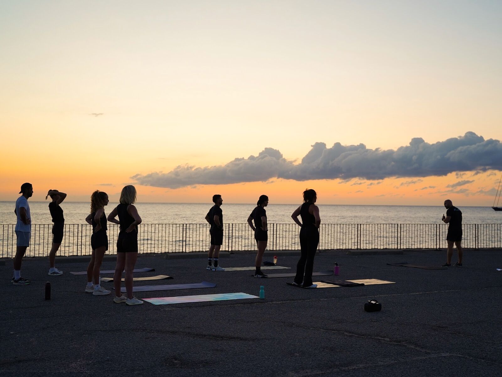 A group training session on the Antibes seafront at sunrise