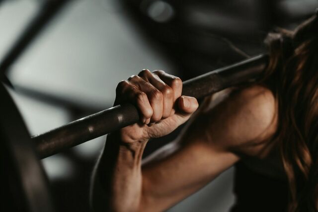 Hands gripping a barbell