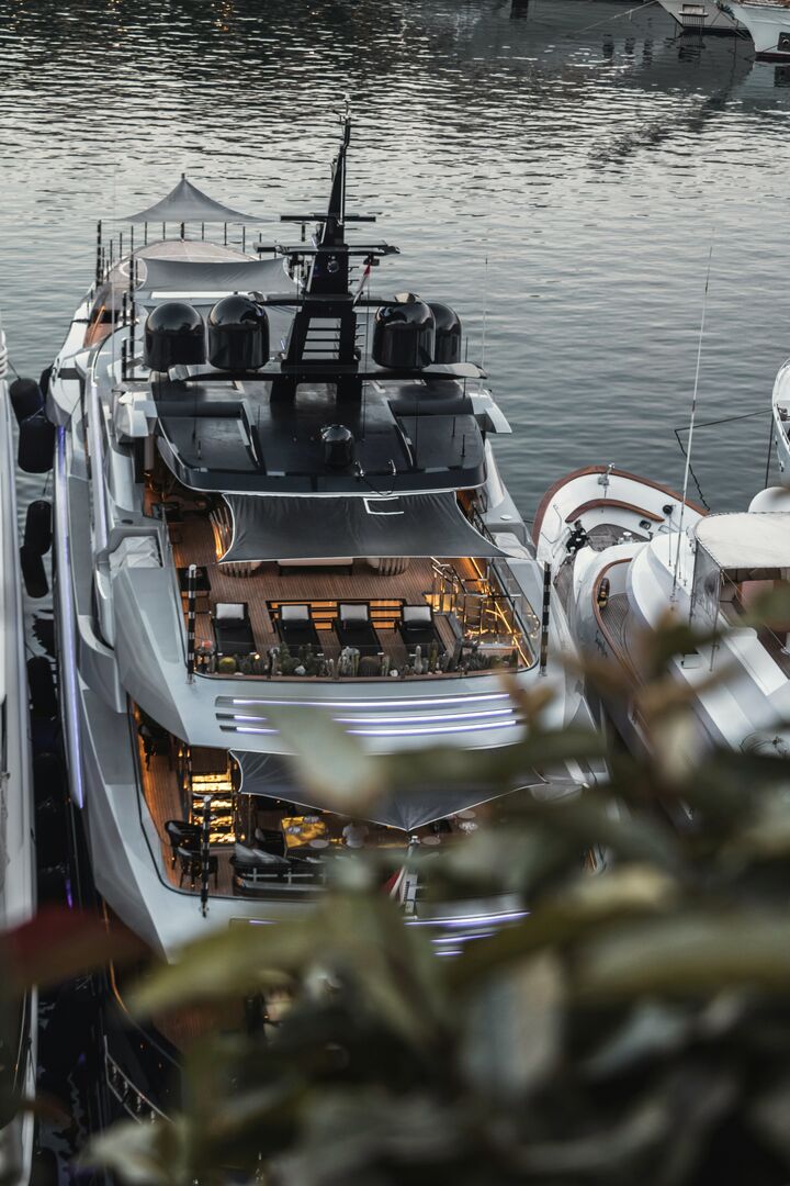 The decks of a yacht moored in a marina, seen from above